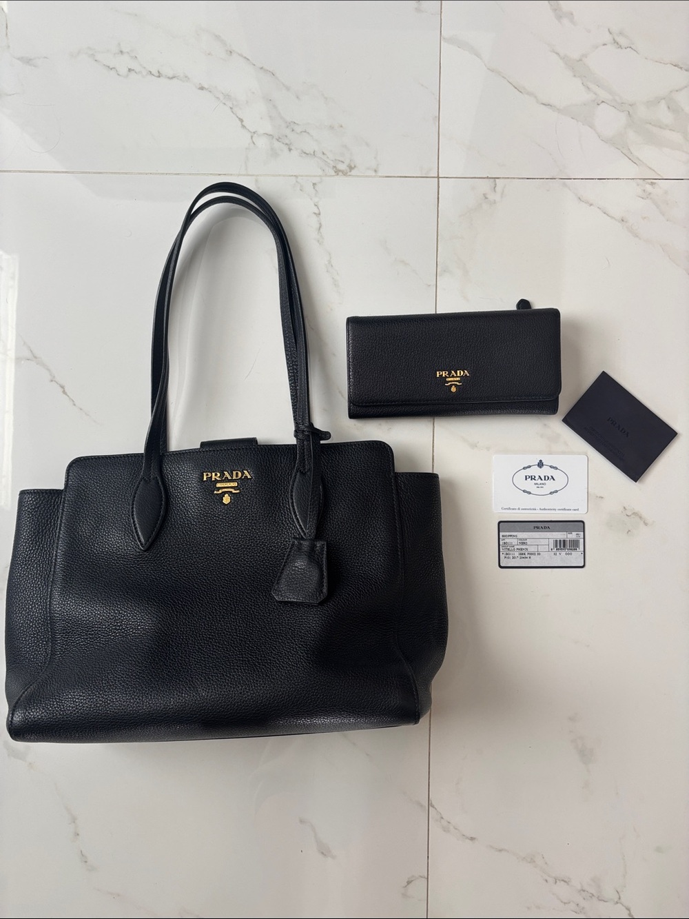 Prada Black Leather Structured Tote with Gold Logo with matching large wallet.
